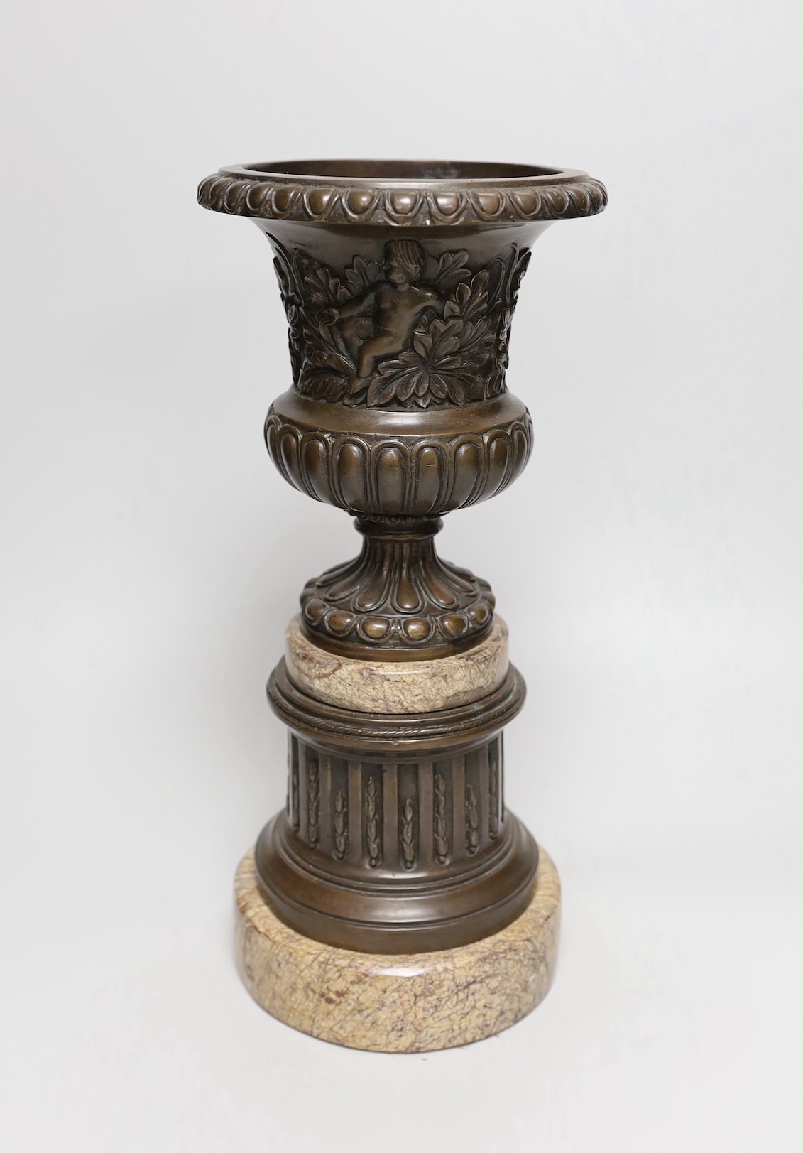 A classical revival bronze and serpentine urn and pedestal, 33cms high